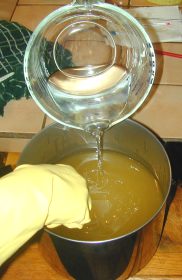 Slowly pour the lye into the warm oils.